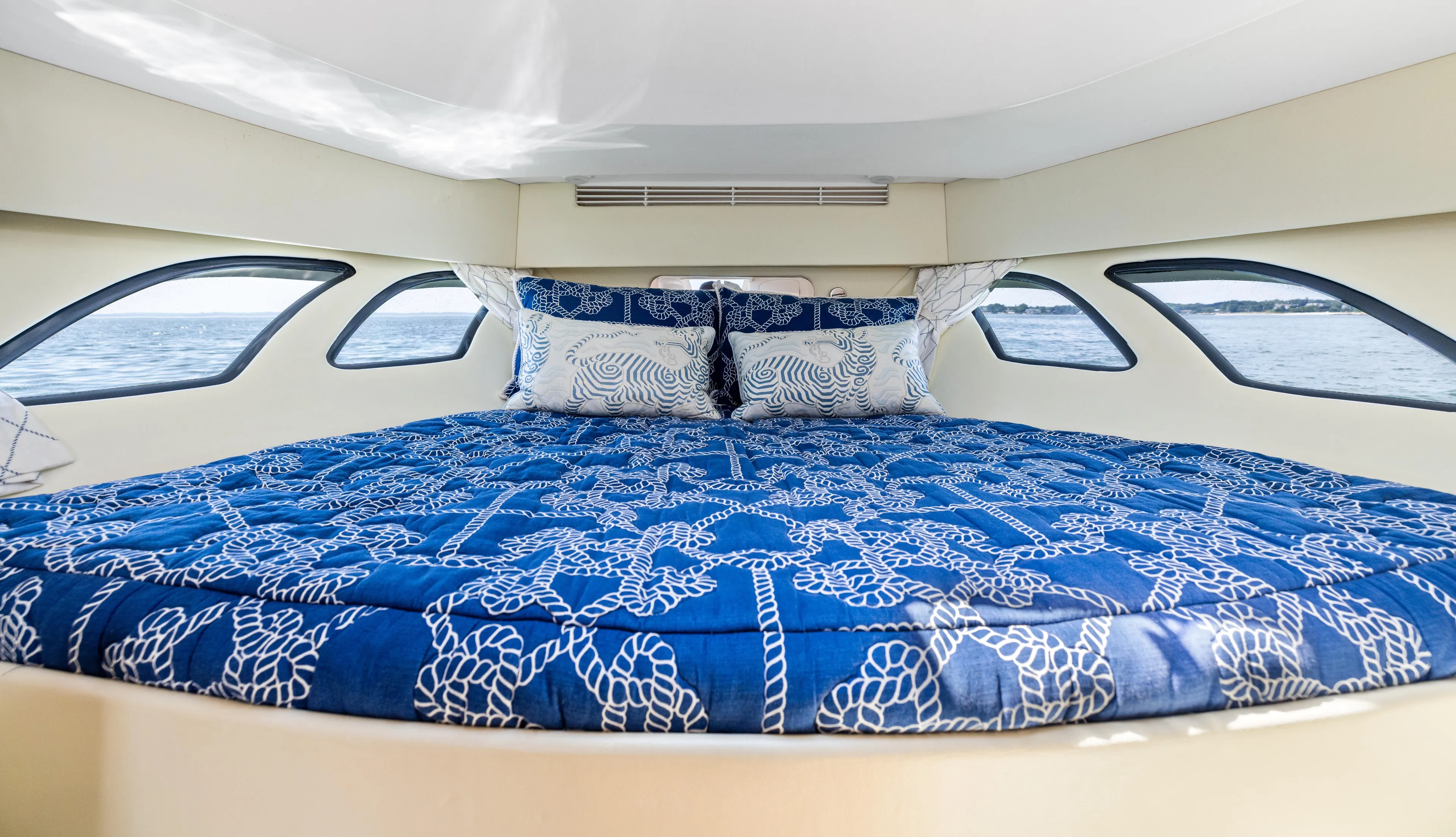 Lil' Sumpin II Yacht Photos Pics Luxurious cabin interior of 2015 Intrepid 430 Sport Yacht with nautical-themed bedding.