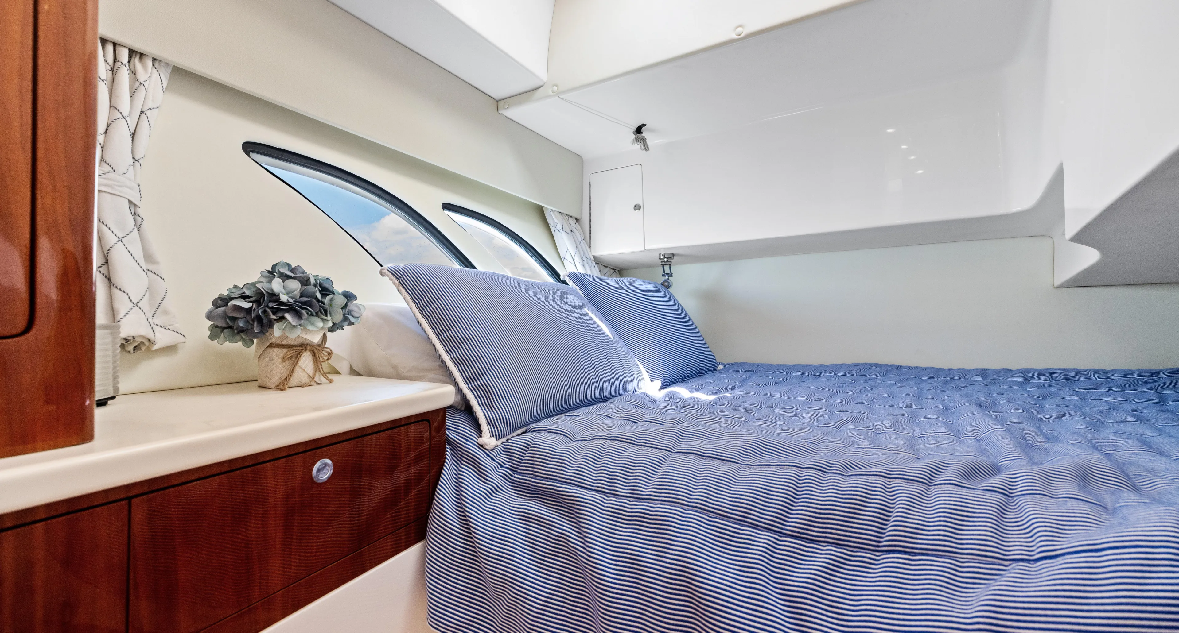 Lil' Sumpin II Yacht Photos Pics Luxurious cabin interior of 2015 Intrepid 430 Sport Yacht with blue bedding and elegant decor.