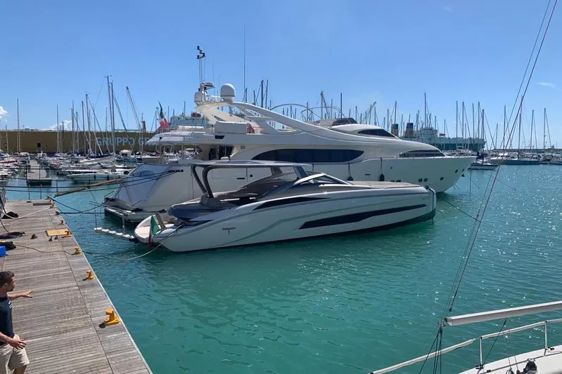 Lamborghini Tecnomar Yacht Photos Pics Luxurious 2017 Tecnomar 55 Evo yacht docked in a vibrant marina setting.