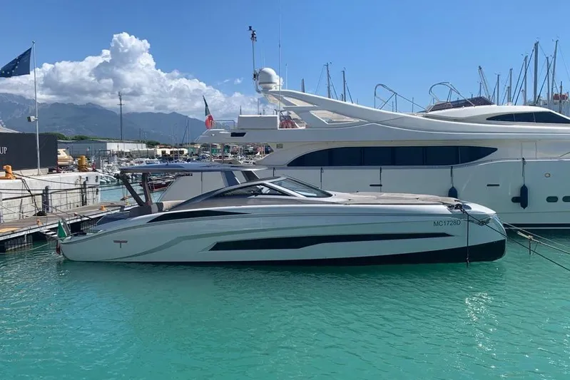 Lamborghini Tecnomar Yacht Photos Pics 2017 Tecnomar 55 Evo yacht docked in a marina with clear blue water.