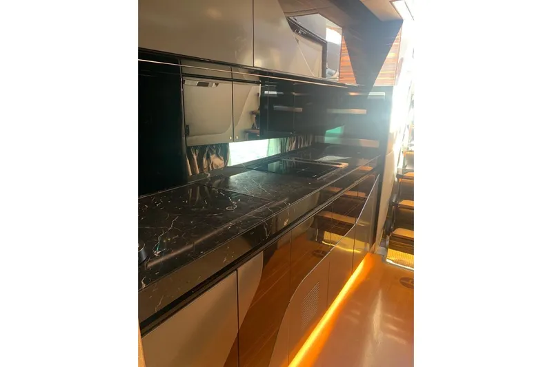 Lamborghini Tecnomar Yacht Photos Pics Luxurious kitchen interior of 2017 Tecnomar 55 Evo yacht with sleek black countertops.