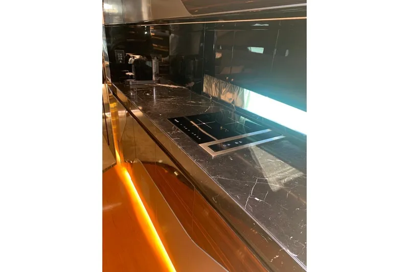 Lamborghini Tecnomar Yacht Photos Pics Luxurious kitchen interior of 2017 Tecnomar 55 Evo yacht with sleek black marble countertops.