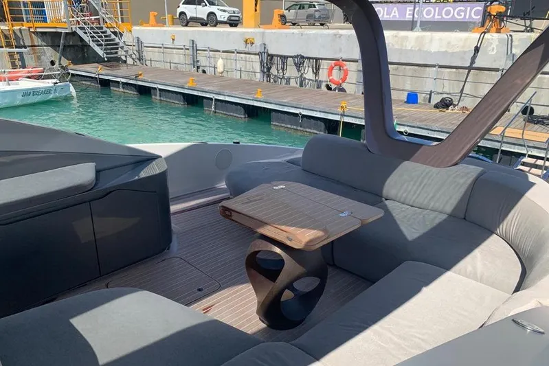 Lamborghini Tecnomar Yacht Photos Pics Luxurious Tecnomar 55 Evo yacht interior with elegant seating and table, docked at marina.