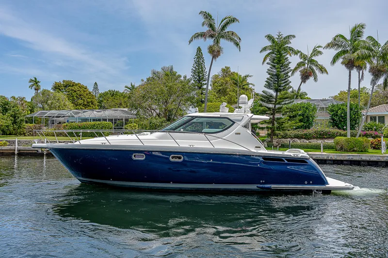 Second Chance II Yacht Photos Pics 2007 Tiara Yachts 4300 Sovran cruising on a scenic waterway with palm trees.