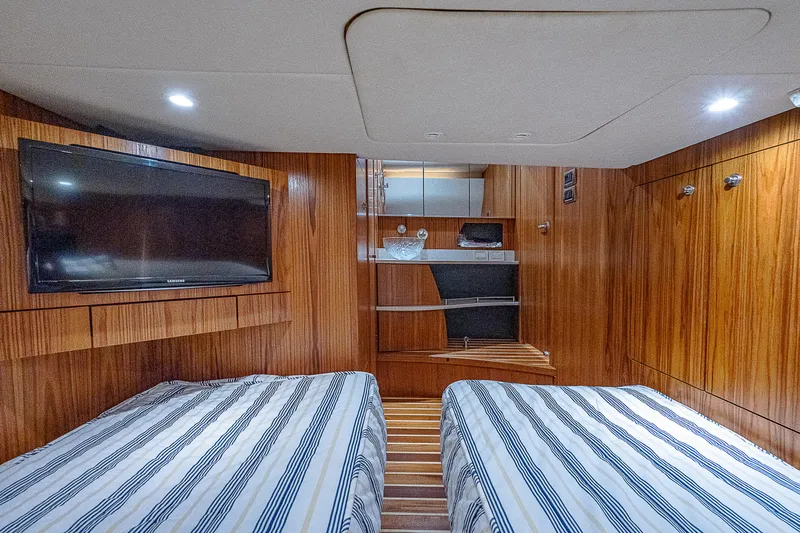 Second Chance II Yacht Photos Pics 2007 Tiara Yachts 4300 Sovran cabin with twin beds, wood paneling, and mounted TV.