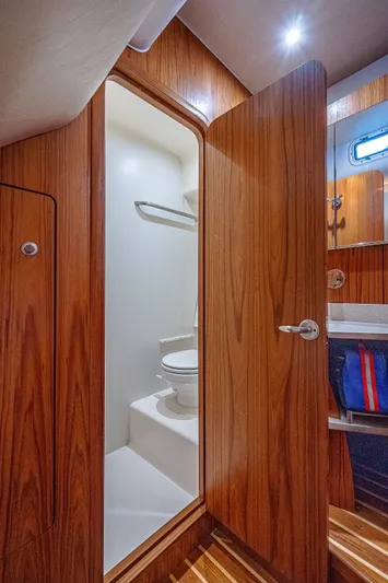 Second Chance II Yacht Photos Pics 2007 Tiara Yachts 4300 Sovran bathroom with wooden door and modern fixtures.