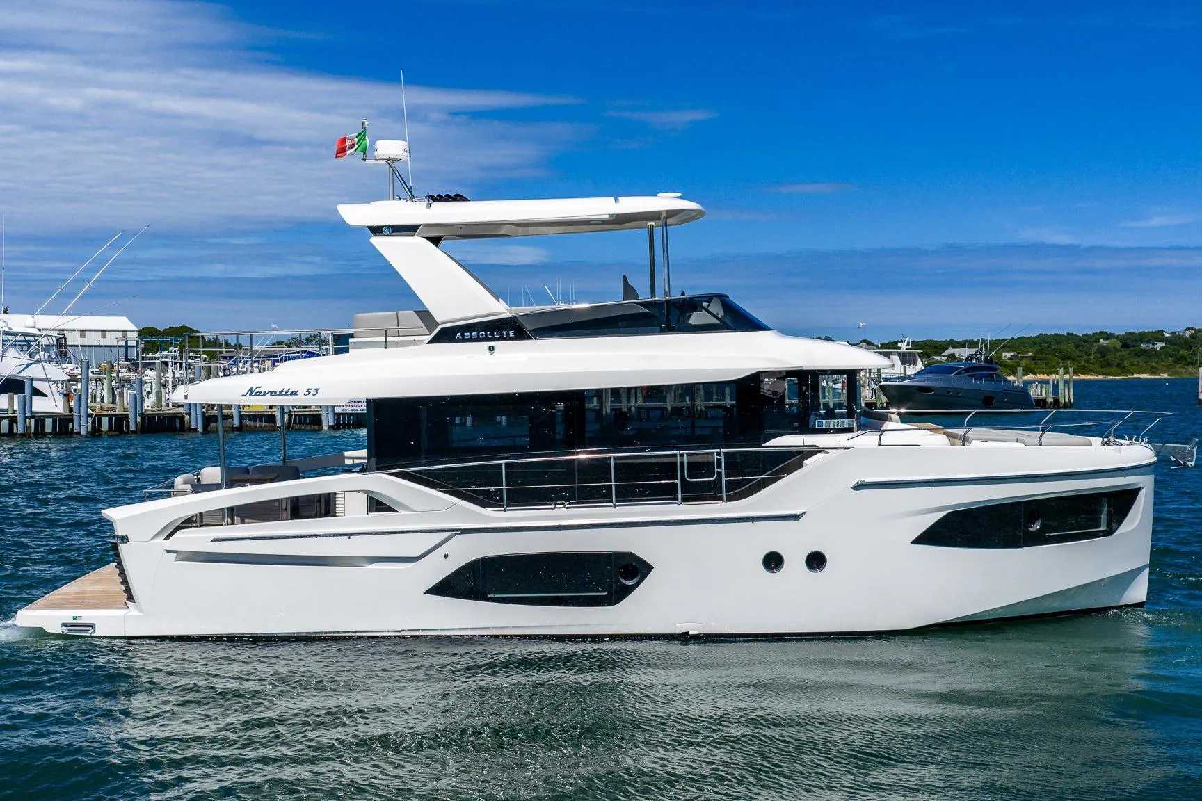 2026 Absolute Navetta 53 yacht on water, sleek design, modern features, blue sky background.