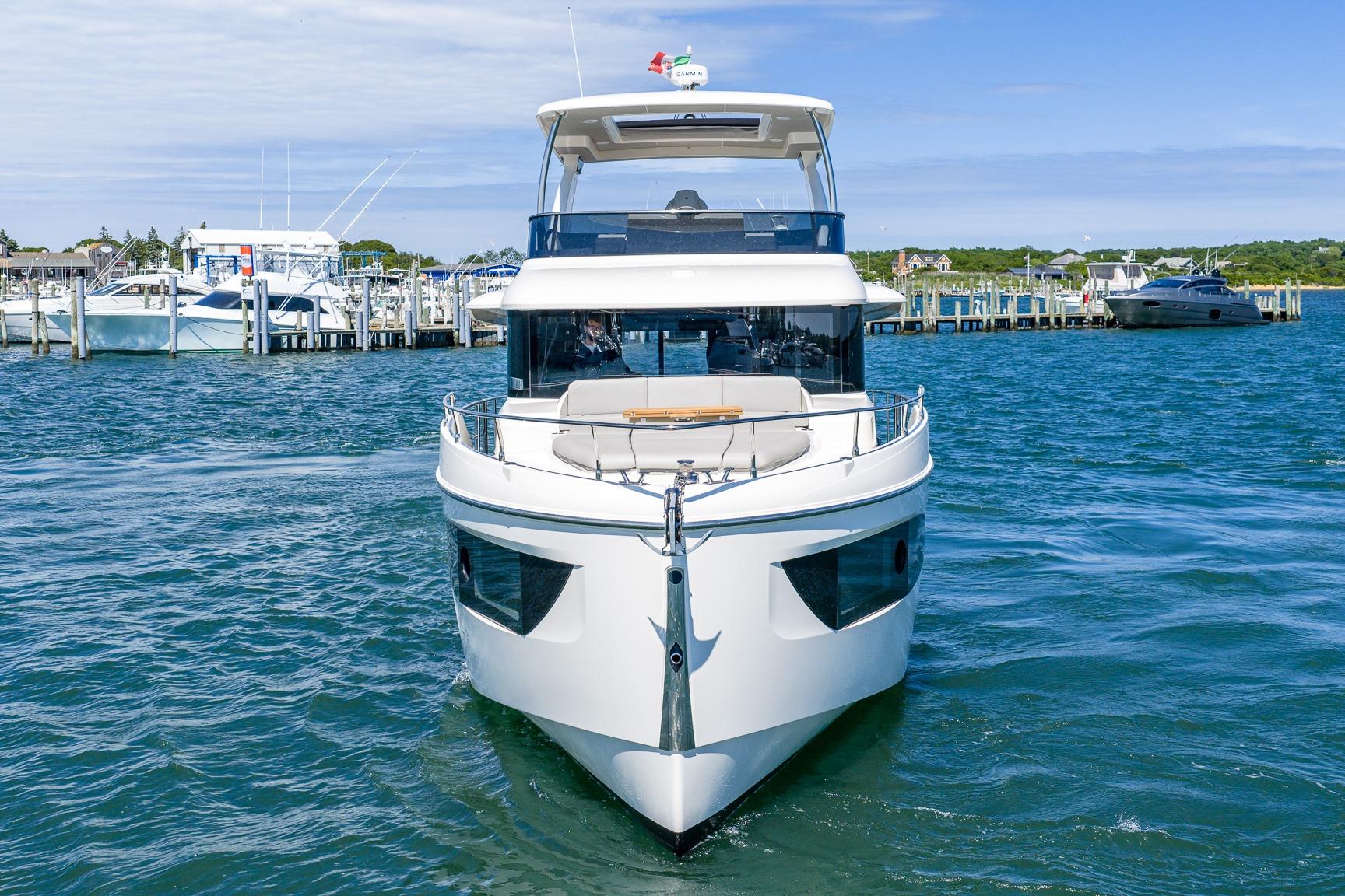 2026 Absolute Navetta 53 yacht docked in a marina, showcasing sleek design and luxury.