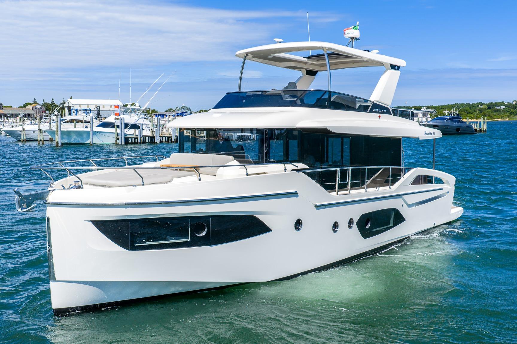 Luxury Absolute Navetta 53 yacht cruising in clear blue waters, 2026 model.