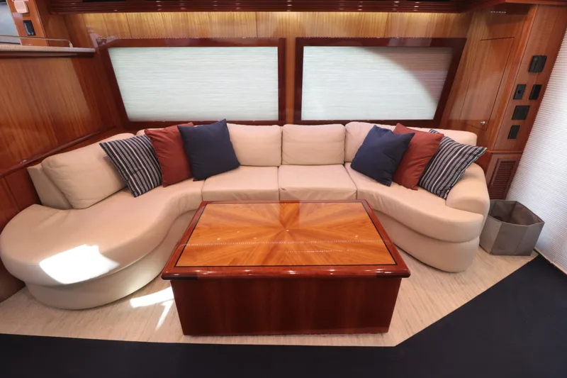 Yacht Photos Pics Luxurious 2007 Hatteras 64 Motor Yacht interior with elegant seating and wooden table.