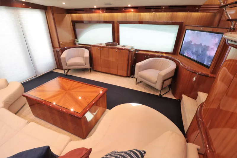 Yacht Photos Pics Luxurious interior of 2007 Hatteras 64 Motor Yacht with elegant wood finishes and plush seating.