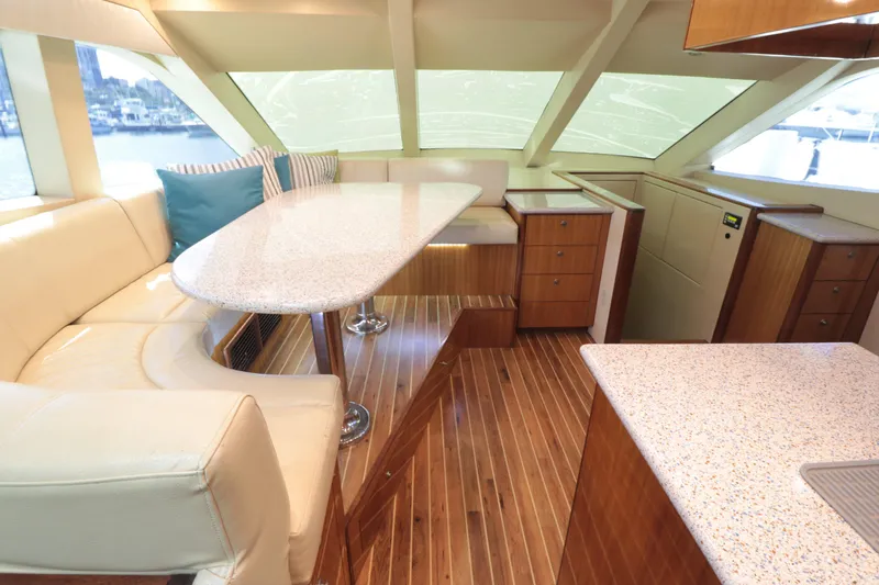  Yacht Photos Pics Luxurious interior of 2007 Hatteras 64 Motor Yacht with elegant seating and wood flooring.