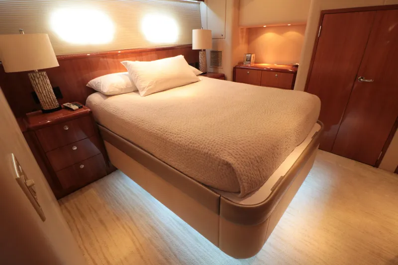  Yacht Photos Pics Luxurious bedroom interior of 2007 Hatteras 64 Motor Yacht with elegant lighting.