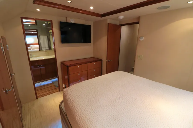  Yacht Photos Pics Luxurious bedroom in 2007 Hatteras 64 Motor Yacht with TV and ensuite bathroom.