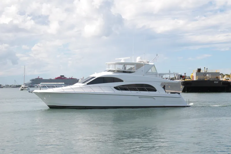  Yacht Photos Pics 2007 Hatteras 64 Motor Yacht cruising in a harbor with cloudy skies.