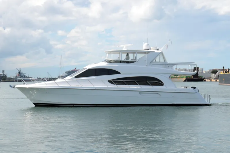  Yacht Photos Pics 2007 Hatteras 64 Motor Yacht on calm water under cloudy sky.
