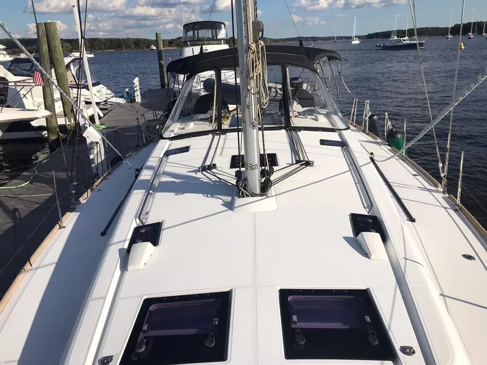 Jinbei Yacht Photos Pics 2014 Beneteau Oceanis 48 sailboat docked, showcasing spacious deck and sleek design.