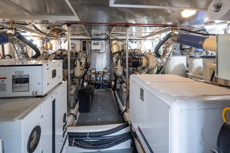 Black Ice Yacht Photos Pics Engine room of a 1998 Ocean Alexander 64 yacht with visible machinery and equipment.