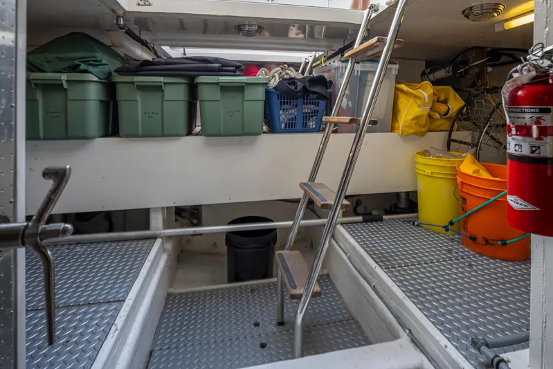Black Ice Yacht Photos Pics Storage area of a 1998 Ocean Alexander 64 yacht with ladder and various containers.
