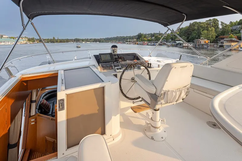 Black Ice Yacht Photos Pics Flybridge of 1998 Ocean Alexander 64 yacht with helm station and scenic water view.