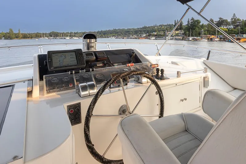 Black Ice Yacht Photos Pics Cockpit of a 1998 Ocean Alexander 64 yacht with steering wheel and navigation equipment.