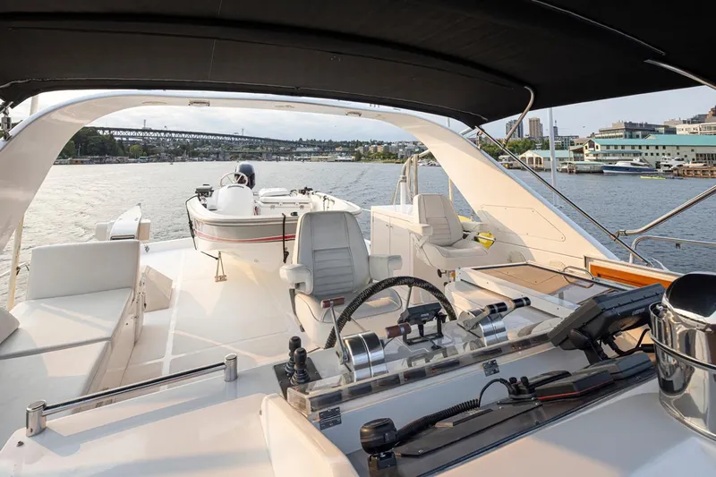 Black Ice Yacht Photos Pics Ocean Alexander 64 yacht 1998 model, spacious deck with seating and steering wheel, waterfront view.