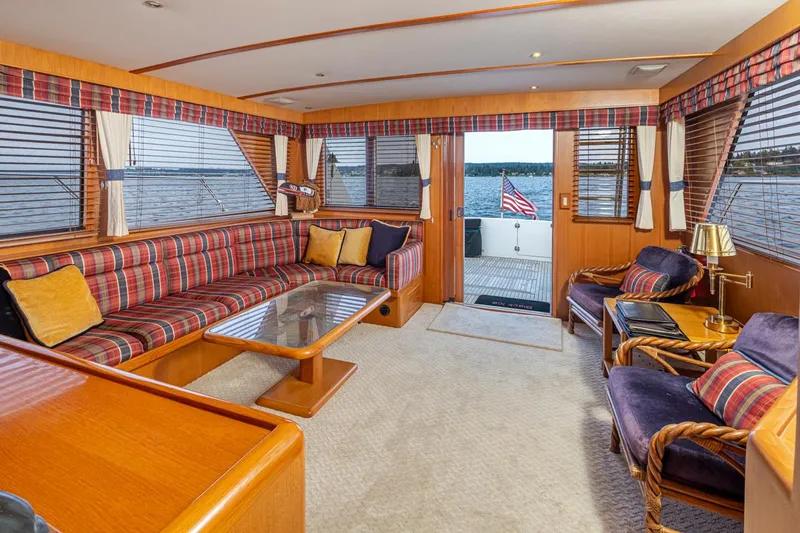 Black Ice Yacht Photos Pics Luxurious interior of 1998 Ocean Alexander 64 yacht with plaid seating and ocean view.