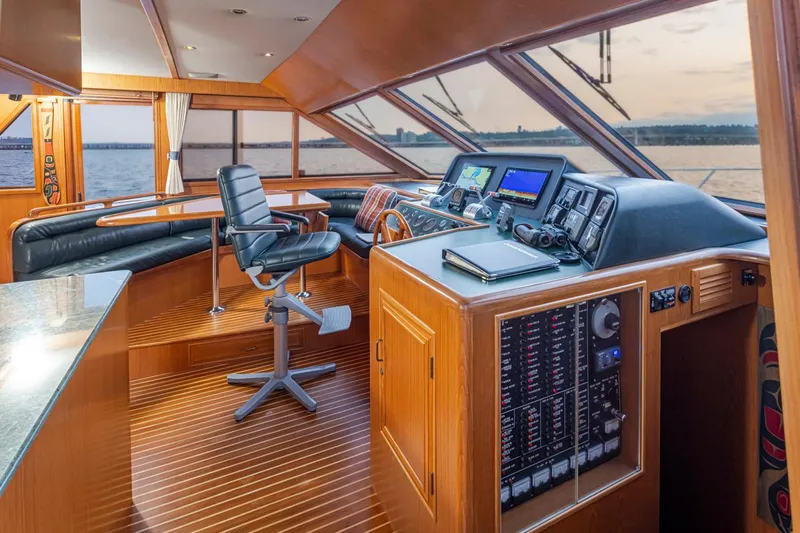 Black Ice Yacht Photos Pics Ocean Alexander 64 1998 yacht helm station with panoramic windows and modern navigation equipment.