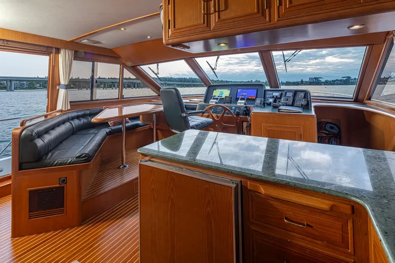 Black Ice Yacht Photos Pics Luxurious interior of 1998 Ocean Alexander 64 yacht with panoramic windows and modern navigation equipment.