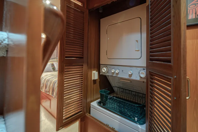 Black Ice Yacht Photos Pics Laundry area with washer and dryer in 1998 Ocean Alexander 64 yacht.