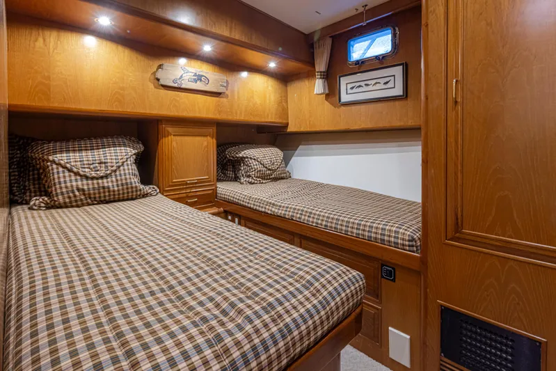 Black Ice Yacht Photos Pics 1998 Ocean Alexander 64 yacht cabin with twin beds and wooden interior.