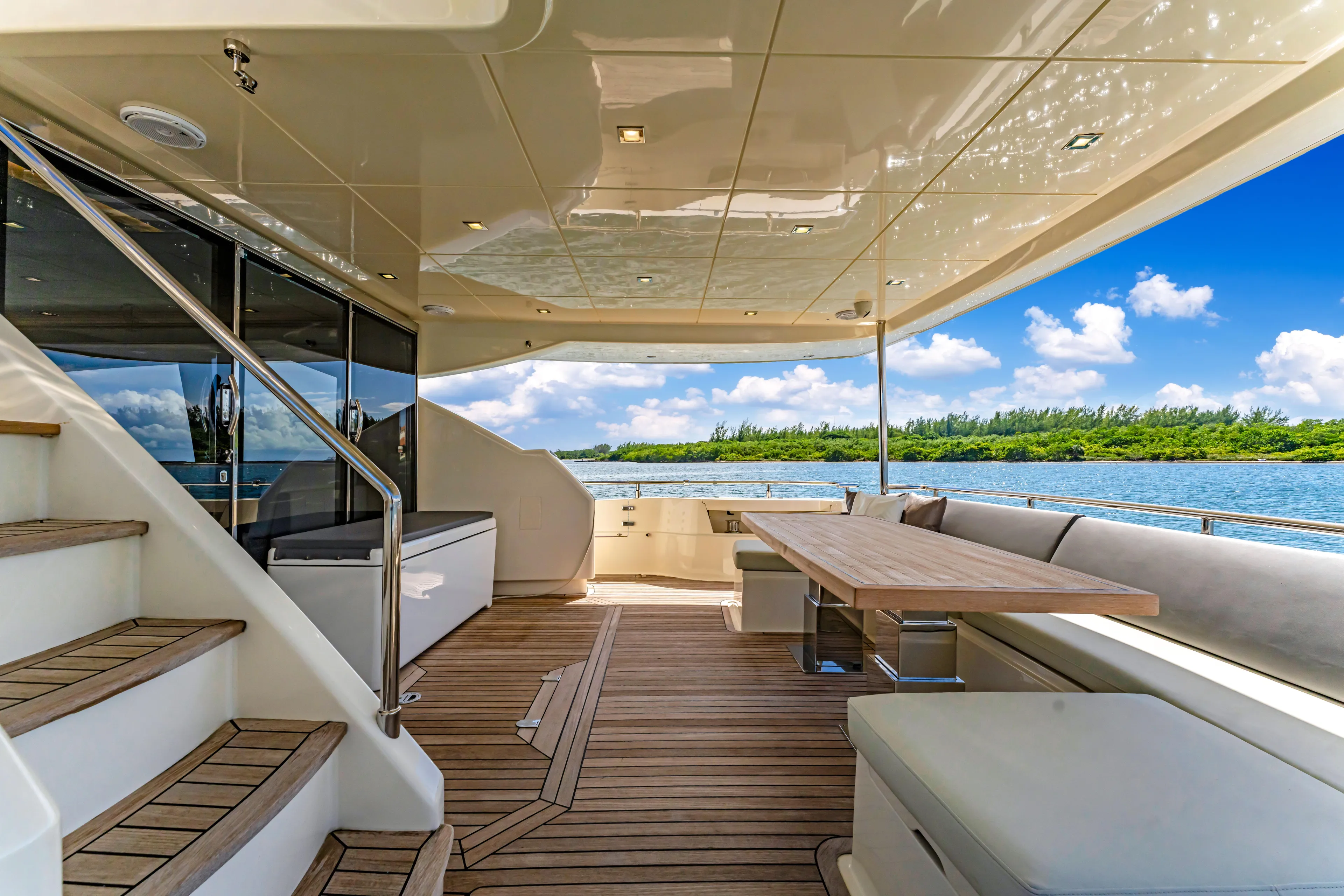 Seaduction Yacht Photos Pics Luxurious 2016 Astondoa 80 GLX yacht deck with elegant seating and scenic water view.