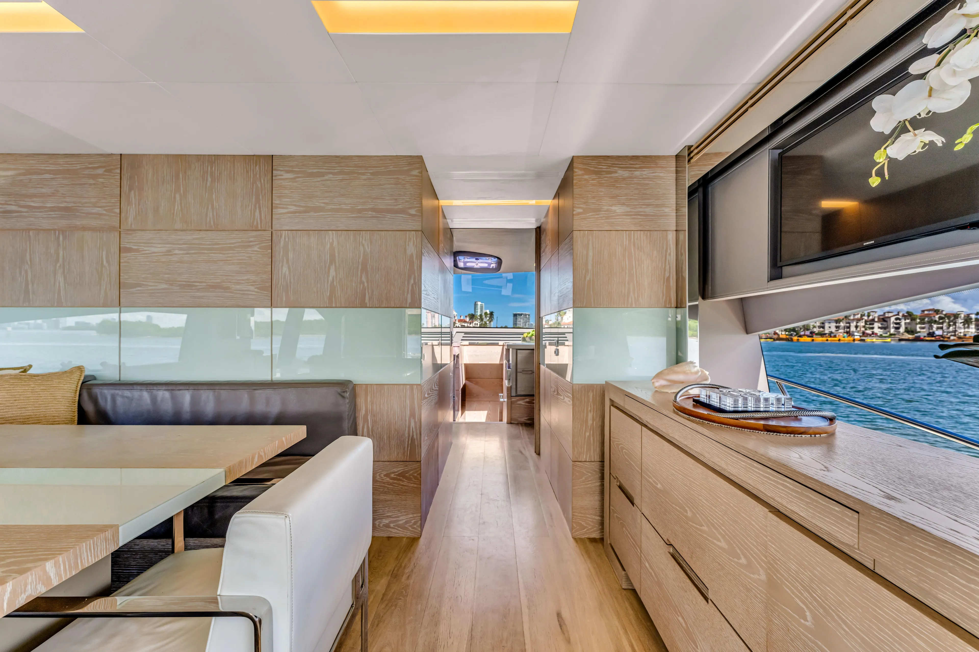 Seaduction Yacht Photos Pics Luxurious interior of 2016 Astondoa 80 GLX yacht with modern dining area and scenic window view.