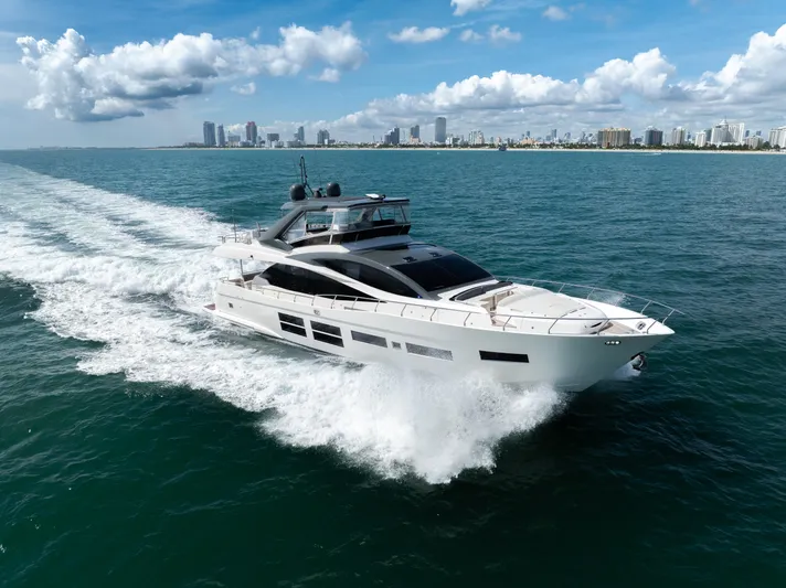 Seaduction Yacht Photos Pics Astondoa 80 GLX 2016 yacht cruising on open water with city skyline backdrop.