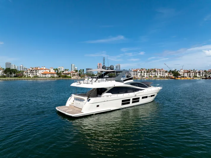 Seaduction Yacht Photos Pics Luxury 2016 Astondoa 80 GLX yacht cruising near waterfront cityscape.