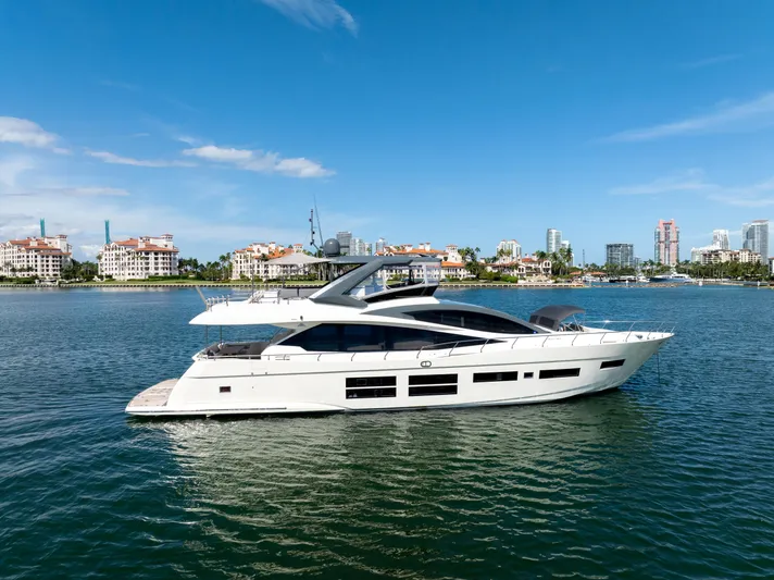 Seaduction Yacht Photos Pics Luxury 2016 Astondoa 80 GLX yacht cruising on a sunny day near coastal cityscape.