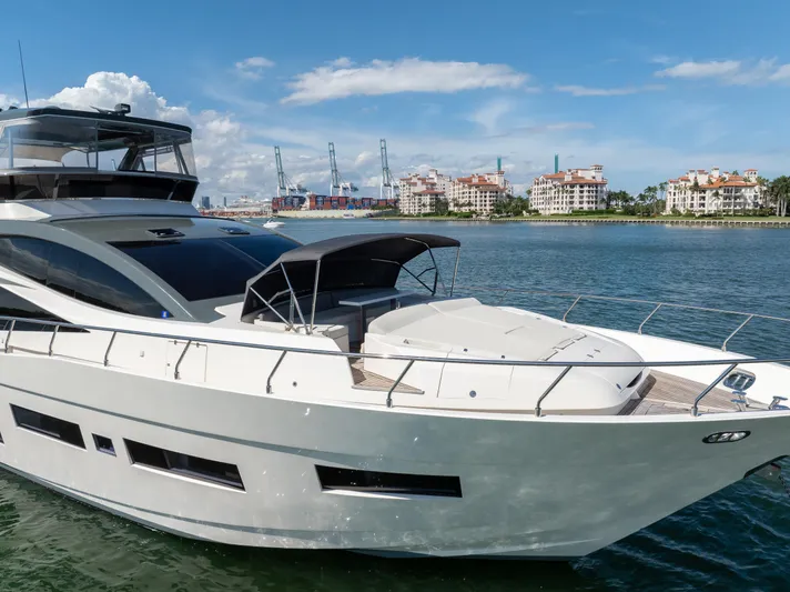 Seaduction Yacht Photos Pics Luxury 2016 Astondoa 80 GLX yacht cruising near coastal cityscape.