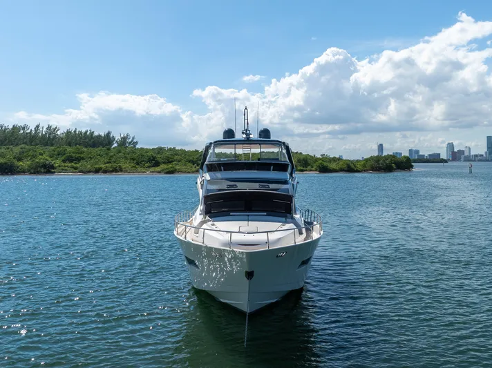 Seaduction Yacht Photos Pics Astondoa 80 GLX 2016 yacht on serene water with city skyline in background.