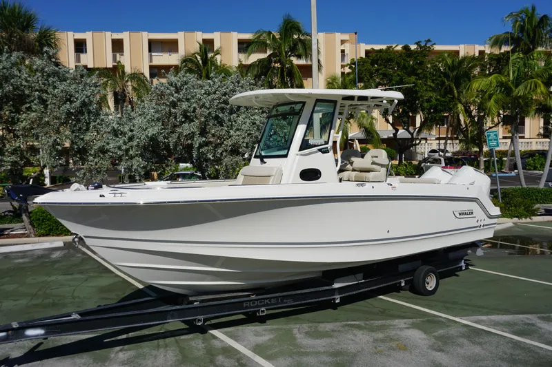 Bwce0767j324 Yacht Photos Pics 2024 Boston Whaler 250 Outrage boat on trailer in parking lot.