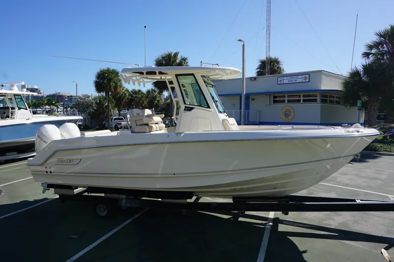 Bwce0767j324 Yacht Photos Pics 2024 Boston Whaler 250 Outrage boat on trailer in marina parking lot.