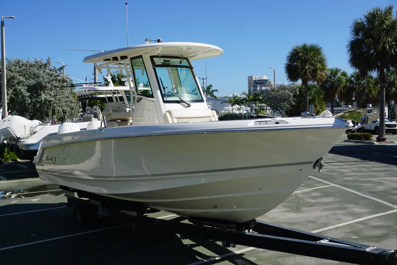 Bwce0767j324 Yacht Photos Pics 2024 Boston Whaler 250 Outrage boat on trailer in sunny outdoor setting.