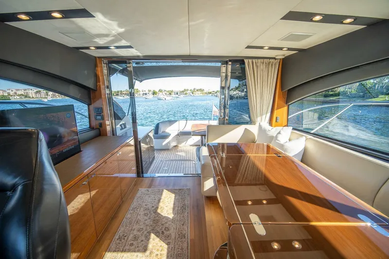Sea-licious Yacht Photos Pics Luxurious interior of 2016 Princess V48 yacht with elegant wood finishes and waterfront view.