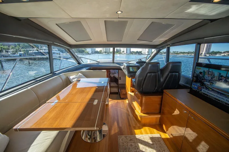 Sea-licious Yacht Photos Pics Luxurious interior of 2016 Princess V48 yacht with elegant seating and panoramic windows.