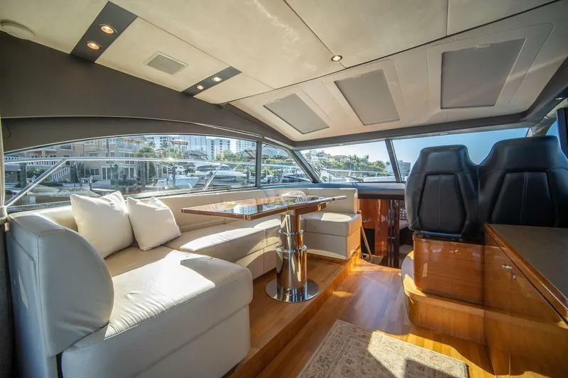 Sea-licious Yacht Photos Pics Luxurious interior of 2016 Princess V48 yacht with elegant seating and panoramic windows.