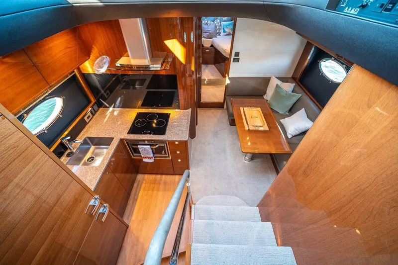 Sea-licious Yacht Photos Pics Luxurious interior of 2016 Princess V48 yacht with modern kitchen and cozy seating area.