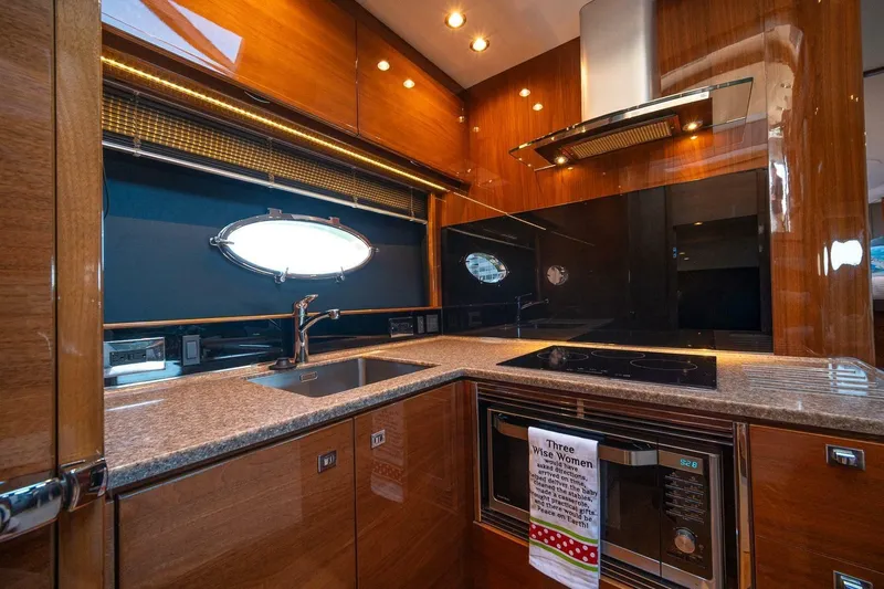 Sea-licious Yacht Photos Pics Luxurious kitchen interior of 2016 Princess V48 yacht with modern appliances and sleek design.