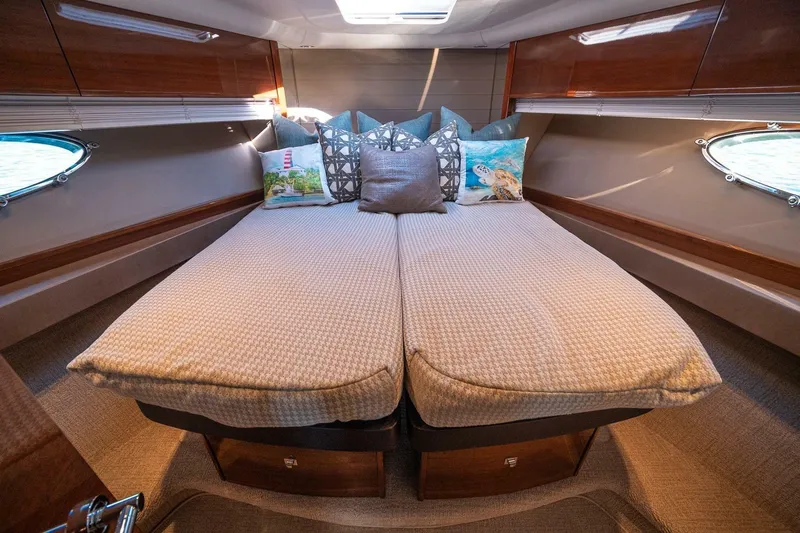 Sea-licious Yacht Photos Pics Luxurious cabin interior of 2016 Princess V48 yacht with cozy bedding and decorative pillows.