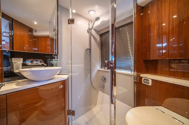 Sea-licious Yacht Photos Pics Luxurious bathroom in a 2016 Princess V48 yacht, featuring modern fixtures and elegant wood finishes.