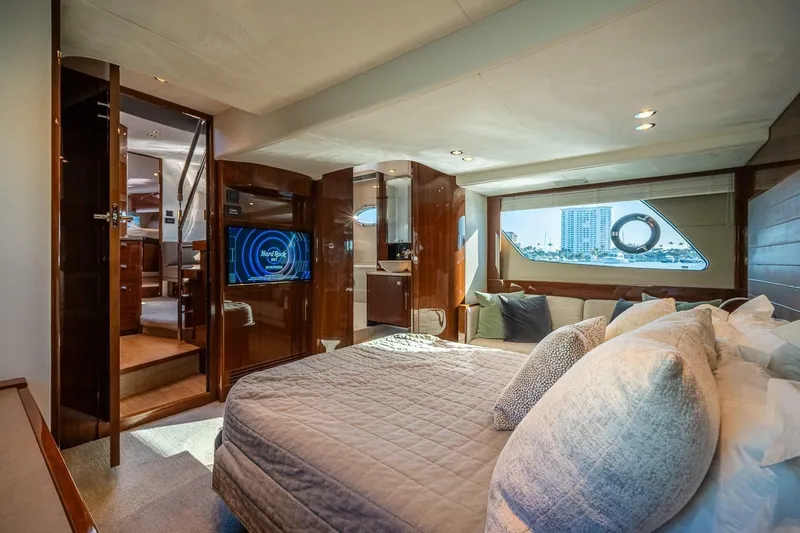 Sea-licious Yacht Photos Pics Luxurious interior of 2016 Princess V48 yacht with elegant bedroom and scenic window view.