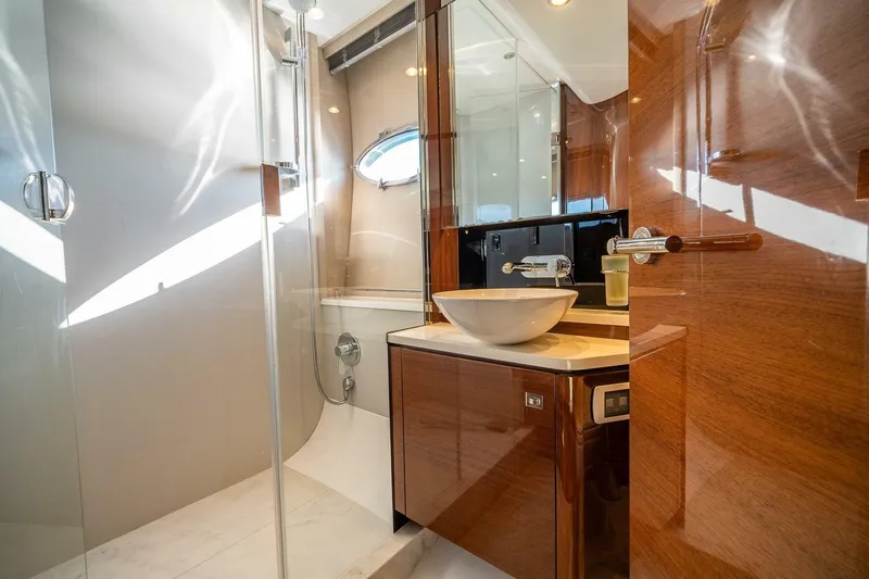 Sea-licious Yacht Photos Pics Luxurious bathroom in 2016 Princess V48 yacht with modern fixtures and wooden accents.